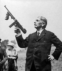 f John T.
                      Thompson holds aloft a stockless M1921
