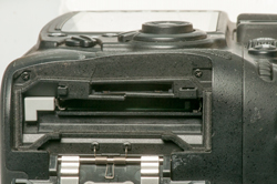 Nikon D300s with
                    broken plastin near memory card sockets