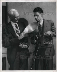 a photo
                    dated September, 5, 1947 on eBay has the following
                    caption: "General Electric's motion detector,
                    using the principle of the VT fuse, is displayed
                    here by W.C. White, left, Research Laboratory
                    electrinics engineer, and H.S. Lasher, a research
                    engineer. Five-inch-long microwaves are sent out by
                    the papabolic (sic) reflector, which also receives
                    the reflected signal. When motion is detected the
                    device can be made to operate a light, ring a bell,
                    and perform other tasks."